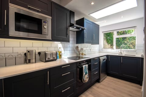 Kitchen with hob, oven, microwave, American fridgefreezer and dishwasher