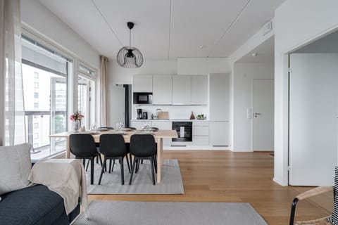 Enjoy dinner with a view! A beautifully set dining table for six in a light-filled open-plan space.