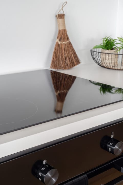 Sleek, fully equipped minimalist kitchen with high-end appliances for a seamless stay.