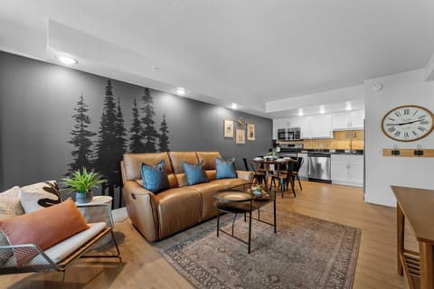 Relax together in the cozy living room, complete with stylish seating, natural light, and easy flow into the kitchen and dining space.