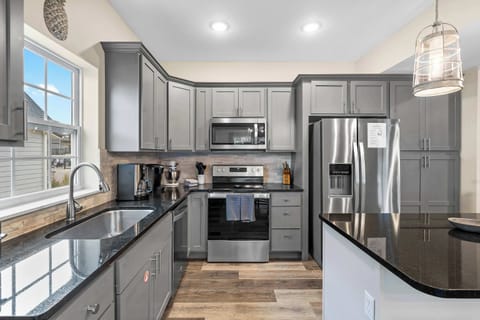 The sleek, open kitchen offers ample space & every home comfort​