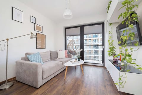 Relax in the stylish living room with a comfortable sofa and modern decor.