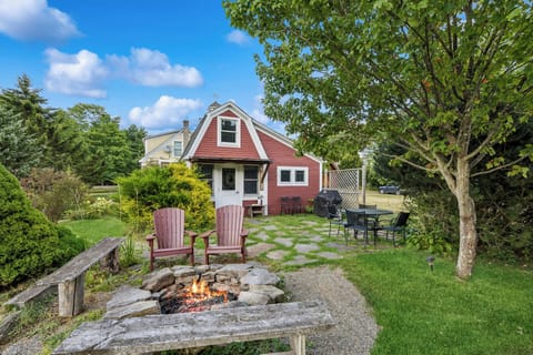 Evening at the cottage with a crackling fire pit and outdoor dining