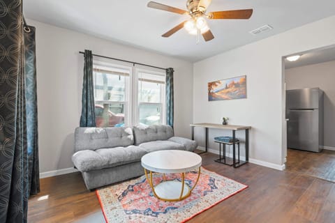 This living room exudes timeless elegance, featuring rich wooden floors, soft neutral tones, and exquisite furniture that adds both comfort and class.
