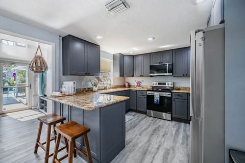 Light-filled and effortlessly stylish, this open-concept kitchen makes cooking, chatting, and connec