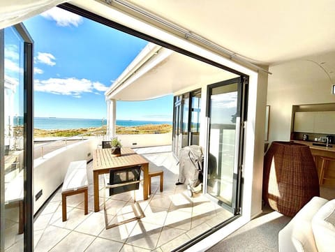 Open Plan Living/Dining out onto upstairs balcony with outdoor dining table and chairs