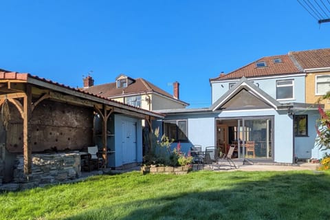 Outdoor space with BBQ next to patio and seating area. 