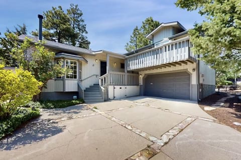 Front of house with EV charger and up to 4 cars