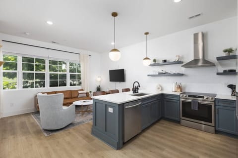 Condo 1 - Fully-stocked kitchen with high-end appliances and seating for 4 at the kitchen counter.