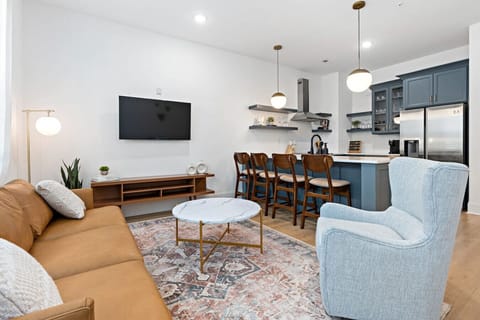 Condo 1 - Lots of natural light in the living room with a Smart TV & all the streaming apps. Open floor plan flows into the kitchen area.