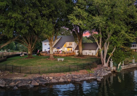 Sunset paints the sky over this stunning lakeside retreat.