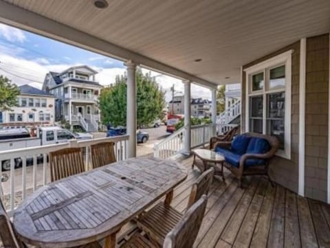 Spacious porch with outdoor dining and furniture
