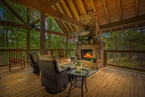 Covered deck with outdoor fireplace and seating.