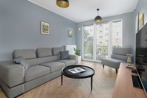 The stylish bedroom includes a comfortable sofa bed and a television.