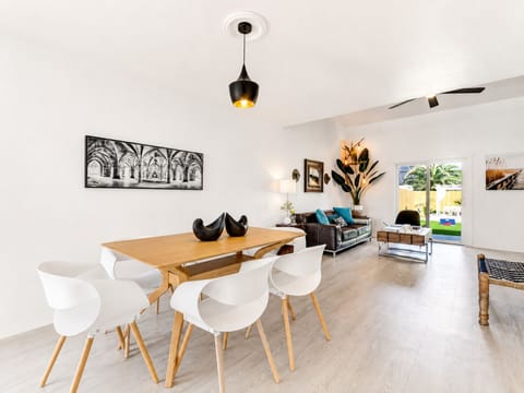Bright modern living-dining space with airy design and patio access