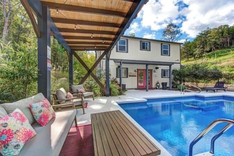 Relax in your covered poolside lounge with comfy seating and colorful cushions, perfect for unwinding after a swim.