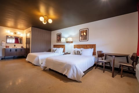 2 queen beds, table with 2 chairs, night stand with charging station
