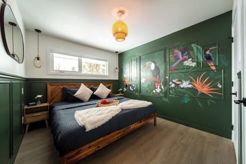 Wake up surrounded by tropical toucans and rich forest tones in this king suite made for deep rest and bold dreams.