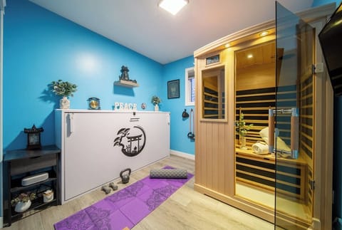 Fitness and relaxation all in one place. A private gym with weights, yoga mats, and a sauna to soothe sore muscles after a workout.