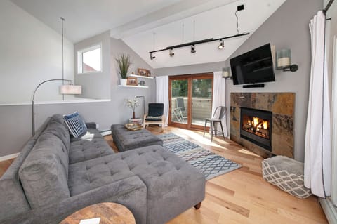 Huge sectional couch and cozy fireplace provide a perfect place to relax