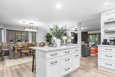Modern white kitchen with updated appliances.