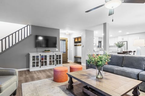 Bright living room with cozy seating and a fireplace.