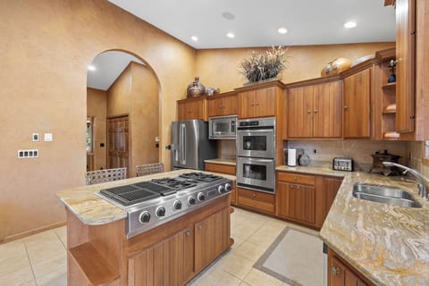 The center island has an 8 burner gas cook top for ease and convenience. 