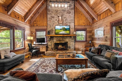 Great Room, perfect to gather around the stone fireplace and enjoy stunning views from oversized windows!