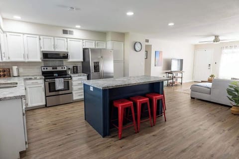 Spacious kitchen with a large island and stainless appliances.