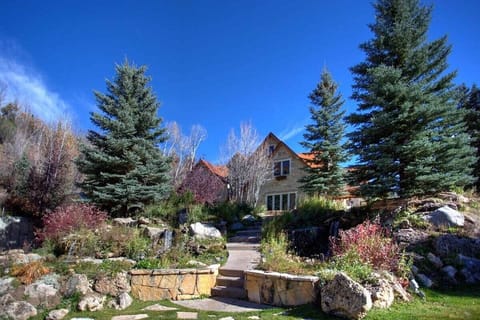 Wander through the tranquil gardens of our mountain estate, featuring stone paths, lush foliage, and majestic pines for a truly peaceful escape.