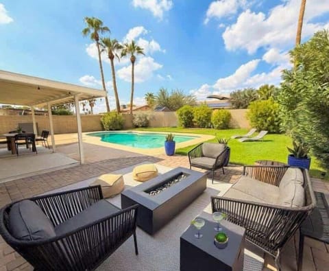 Relax in style with our outdoor lounge, featuring cozy seating, a modern fire pit, and views of the sparkling pool perfect for day or night.