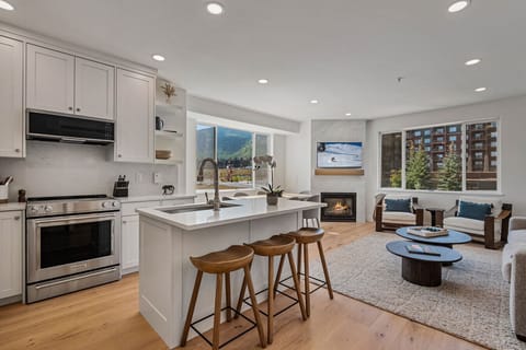 Bright open concept living room and well stocked kitchen