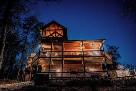 View of the cabin and multiple decks for your group to gather.  Includes hot tub, hammock, and other seating options.