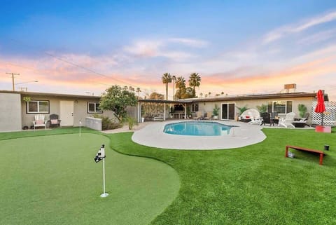Sunset hangs over the backyard—take a few putts on the green, then cool off in the pool while the sky turns pink. Wide turf space makes it easy for everyone to spread out and stay outside a little longer.