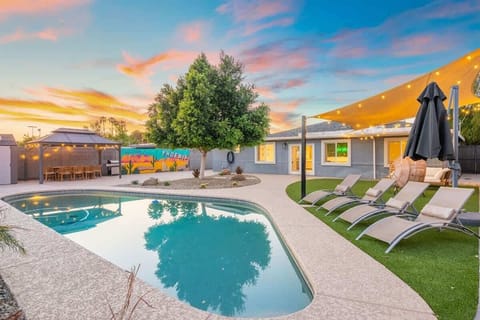 Sunset swims in the backyard pool, with lounge chairs lined up for post-dip drying off. Grab a seat under the umbrella watch the sky turn pink, and let the patio lights set the mood. Chaises on the lawn let everyone snag a sunbeam now at dusk.