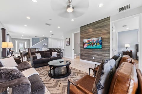 Bright, stylish living room with comfy seating for the whole family. A cheerful place to unwind after fun-filled Orlando