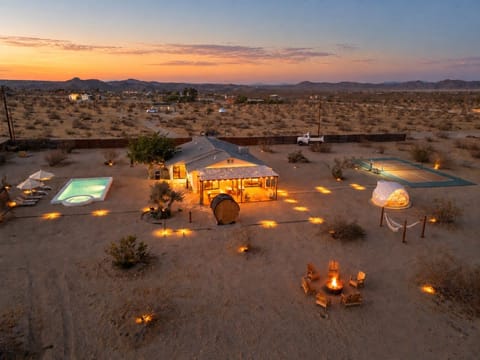 A private Joshua Tree retreat beneath a sea of stars, perfectly located to experience the best of the desert. Unique design meets desert soul, with a pool, hot tub, sauna, stargazing dome, pickleball, fire pit, game room,