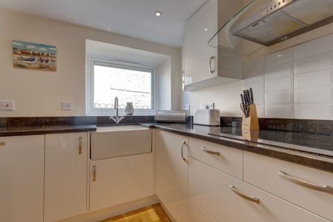 Ground floor: Kitchen area with an electric oven and hob, microwave, dishwasher and fridge