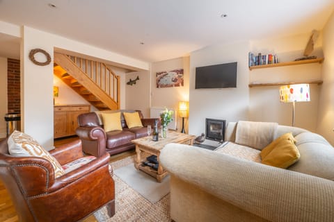 Lovedays: Sitting room area with a Smart television and wood burning stove