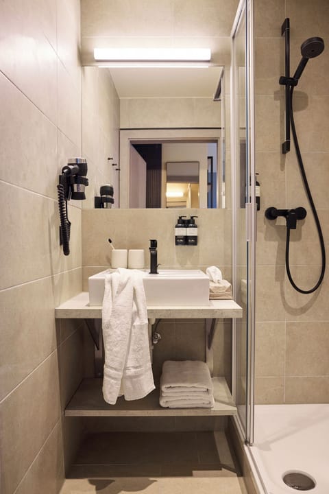 Shower, designer toiletries, hair dryer, bathrobes