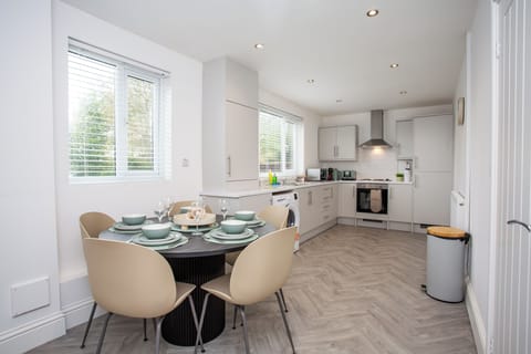 Modern kitchen with all essentials and a stylish dining setup