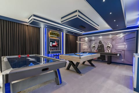 Enjoy hours of fun in our vibrant game room, complete with sleek air hockey and foosball tables, all surrounded by striking blue accents and bold decor. The modern design and playful atmosphere promise entertainment for everyone.