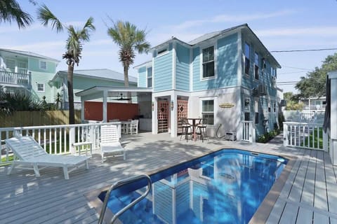 This bright and inviting two-story beach house features charming coastal VIBES with the outdoor space is a vacationer's dream complete with a private pool, sun loungers, and a spacious deck perfect for relaxing in the sun.