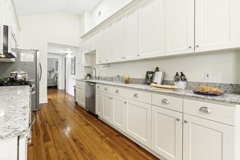 Kitchen | Fully equipped galley-style kitchen with stainless steel appliances, granite countertops, and ample cabinet space