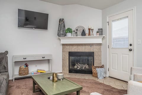 Inviting living room with smart TV, fireplace, and plenty of comfort.