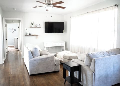 Inviting living room with smart TV and plenty of comfort.