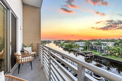 Watch the day fade into warm twilight hues while city lights twinkle just beyond the water.