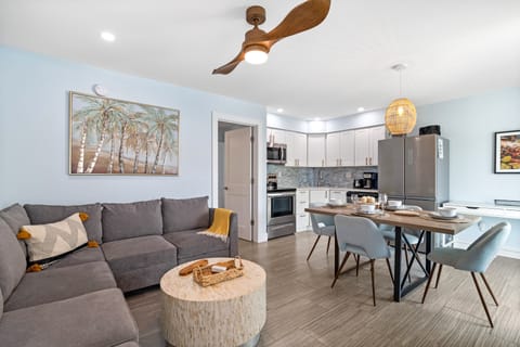 Sea Angel's Living Area, Featuring a Pull-Out Sleeper Couch, A Dining Table, A Fully Stocked Kitchen, and a Desk.