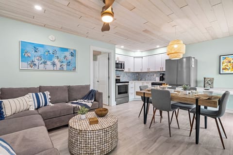 Step inside from the bright patio and feel the gentle coastal breeze blend with the warm, inviting comfort of this open living area.