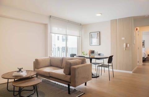 Bright and cozy living room with large windows and stylish decor.
